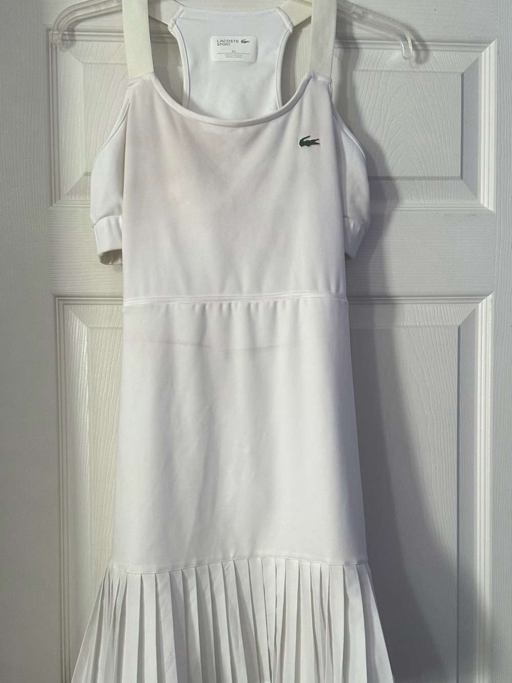Lacoste Sport racerback tennis dress with a pleated hem is a size 10
